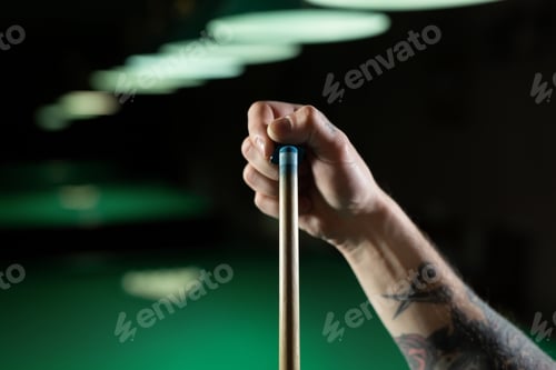 Preview: Close up of a unrecognizable man chalking pool cue.