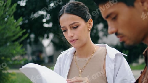 Preview: Closeup woman working papers at nature. Busy business couple analysing documents