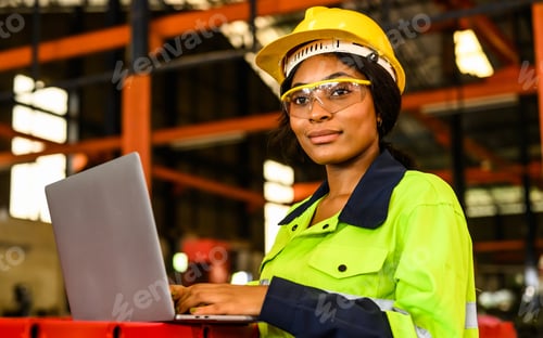 Preview: Portrait of happy female maintenance engineer checking and controlling machine