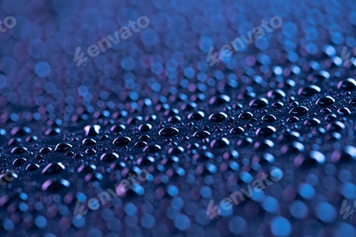 Preview: close up view of water drops on blue surface as background
