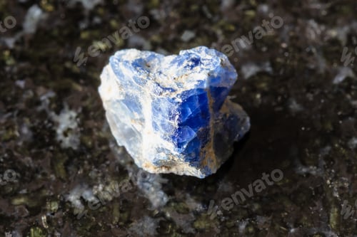 Preview: sample of rough benitoite rock on black granite