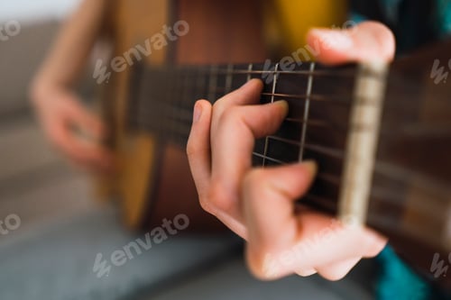 Preview: Close-up of woman playing guitar