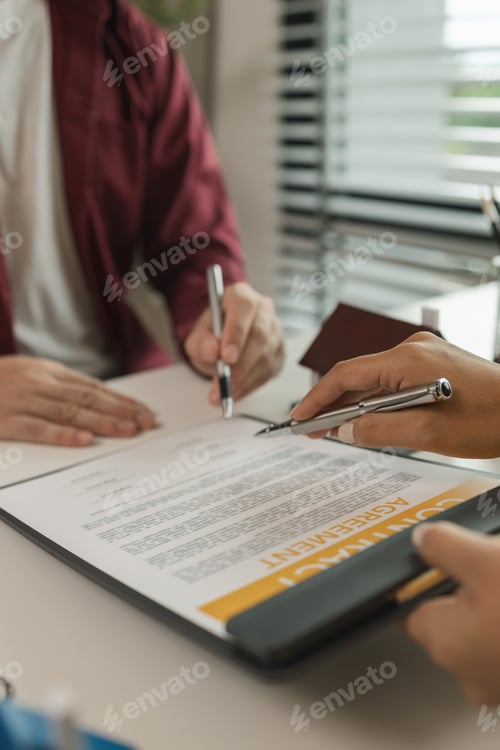 Preview: A man signs a contract after agreeing to buy a house with an agent. The agent explains the details o