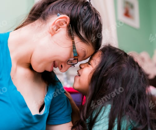 Preview: Mother and diverse pre school daughter at home playing and having fun