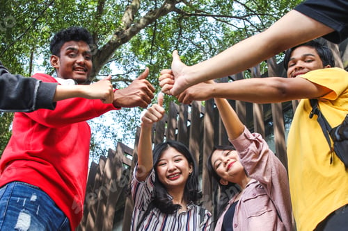 Preview: Group of happy multiracial students smiling with thumbs up