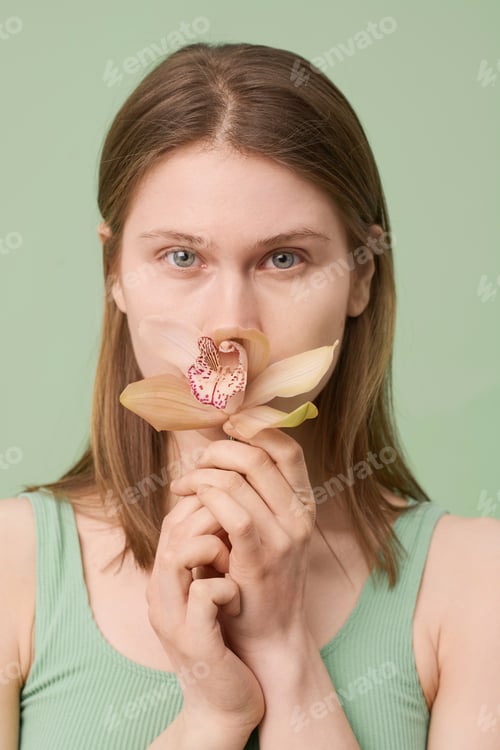 Preview: Young Woman Smelling Flower