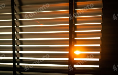 Preview: Opened venetian plastic blinds with sunlight in the morning. White plastic window with blinds.