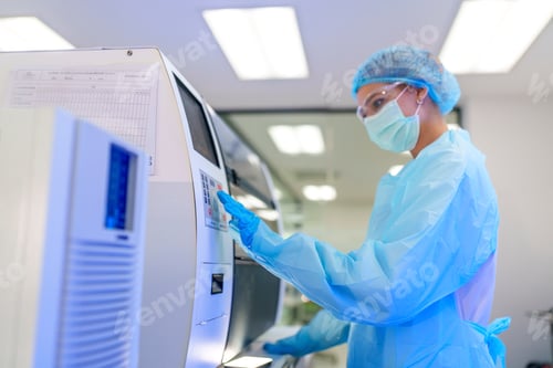 Preview: Laboratory technician operating equipment in a medical facility during daytime