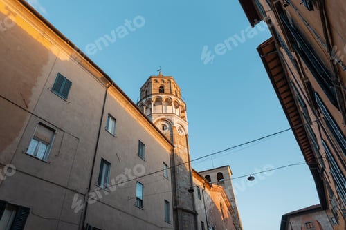 Preview: Old vintage church building at sunset in a historic cozy European town in Italy