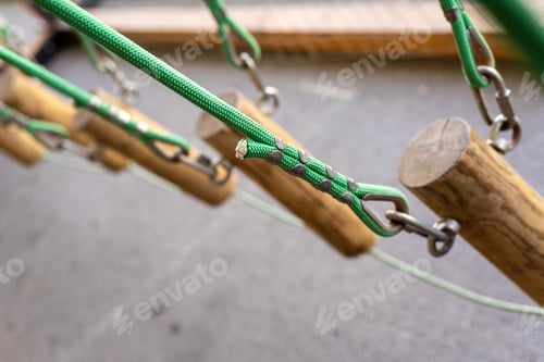 Preview: Trunks suspended by ropes in an adventure park.