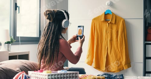 Preview: Woman taking pictures of her clothes