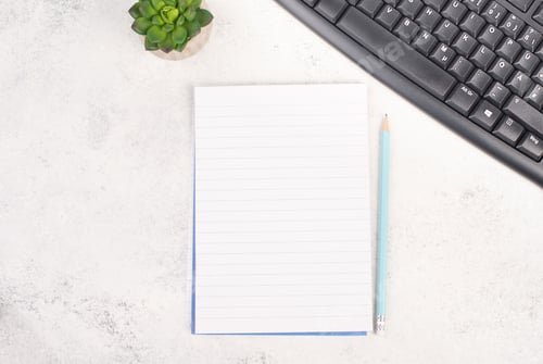 Preview: Empty paper with a pen, computer keyboard and a cactus, textured background, brainstorming