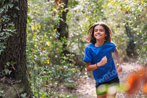 Preview: girl practicing trail running in the woods