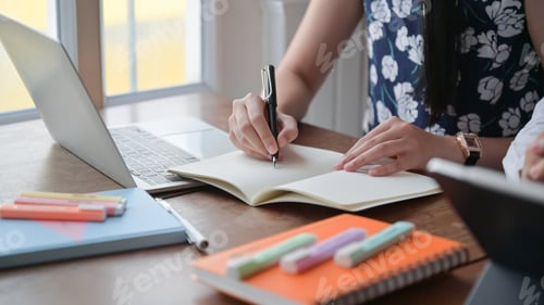 Preview: Young woman recording online meetings at her home,work from home to prevent the virus.