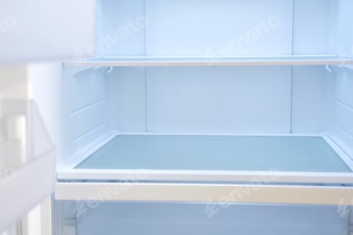 Preview: Modern white open refrigerator close-up with empty shelves, front view.