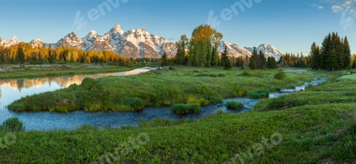 Preview: Panorama of the Grand Teton mountains above a river in early morning light