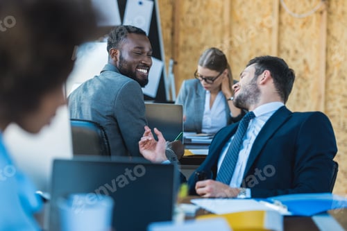 Preview: smiling multicultural businessmen talking in office