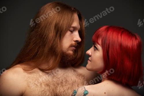 Preview: Sexy couple in love. Close-up of a beautiful semi-nude man and woman with red hair and colored