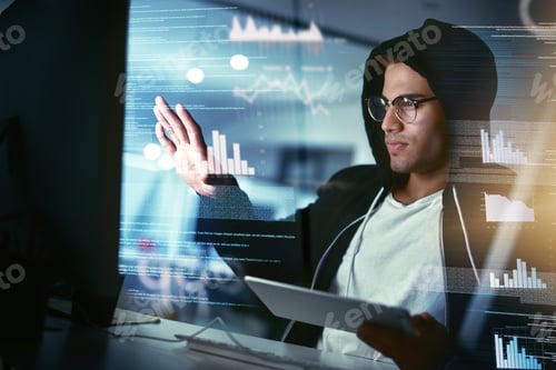 Preview: Hackers are the masters of stealth. Shot of a young hacker cracking a computer code in the dark.