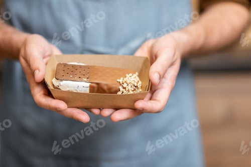 Preview: Seller with chocolate ice cream, close-up