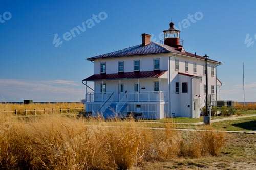 Preview: Beautiful white farmhouse in the field on a sunny day