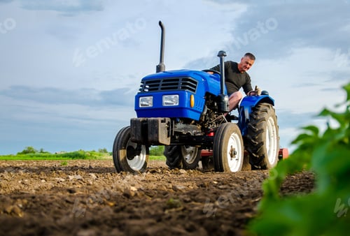 Preview: A farmer on a tractor works in the field.