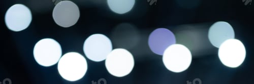 Preview: bokeh lights. blurred night white blue gray abstract texture glowing neon light on black background.