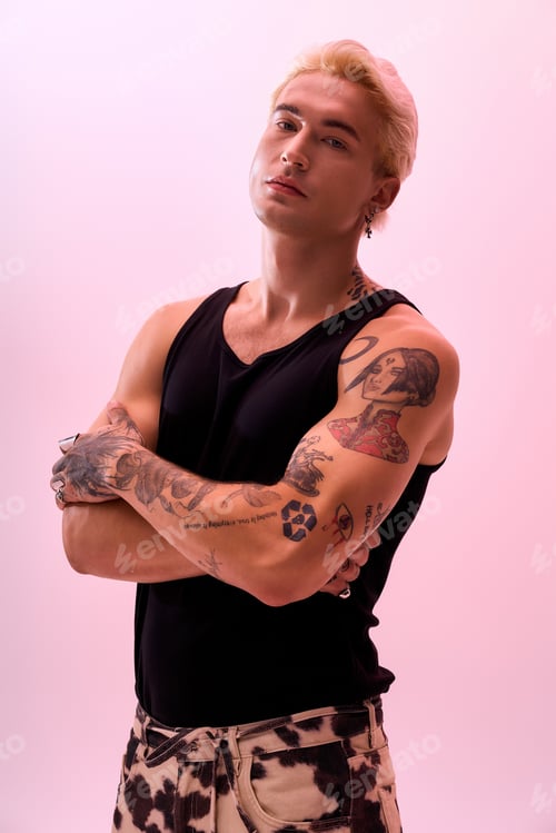 Preview: Young man showcases stylish fashion with confidence in a modern studio setting