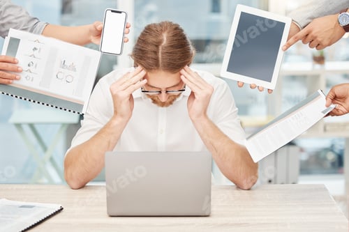 Preview: Shot of a young businessman looking stressed out in a demanding office environment