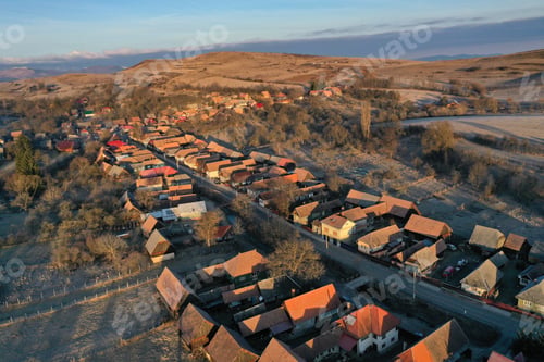 Preview: Aerial view of residential houses in a village during morning sunrise lights