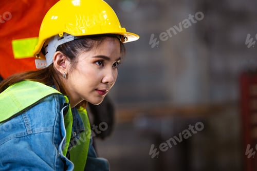 Preview: Female factory worker or engineer looking forward with blank space. labor and employment