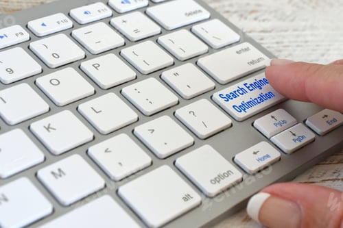 Preview: Search engine optimization concept - Woman pushing a SEO button on a white computer keyboard.