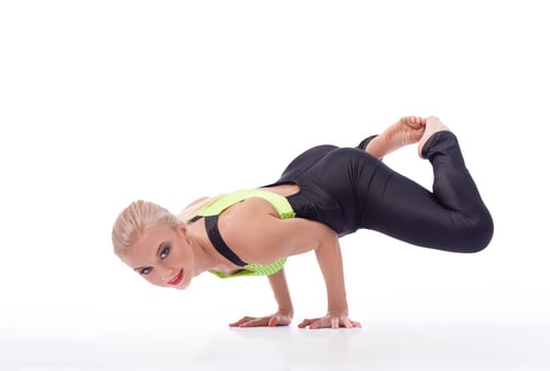 Preview: Attractive female gymnast exercising at studio