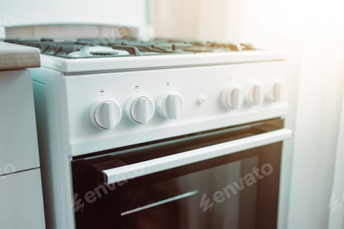 Preview: Close up of stylish new white gas stove in a kitchen