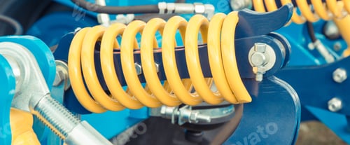 Preview: Hard spring made of steel. Part and detail of blue industrial or agricultural machine