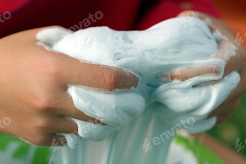 Preview: Closeup of child playing with slime foam