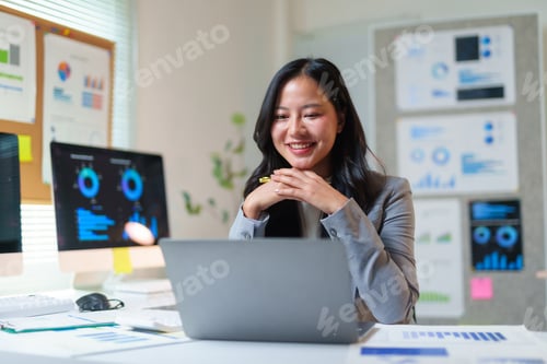 Preview: Asian businesswoman having video call, working on data analysis