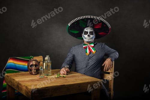 Preview: Catrin wearing mariachi hat and raising a toast in a bar. Day of the dead celebration.