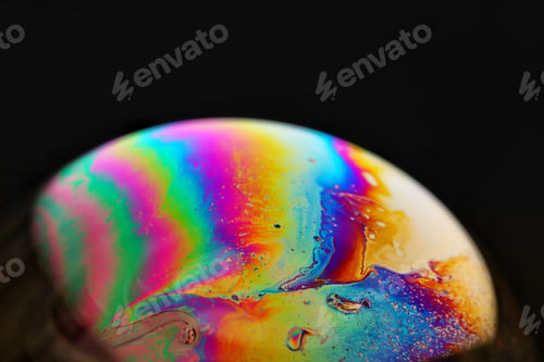 Preview: Vibrant, rainbow-hued soap bubble against a dark background.