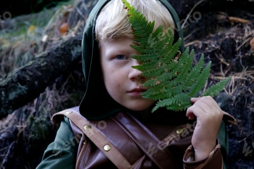 Preview: Close up portrait of a boy in a medieval costume against a forest background