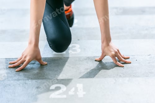 Preview: partial view of sportswoman in starting position on stadium stairs, fitness woman running concept