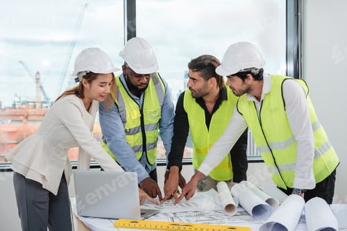 Preview: Engineers meet in the office to work on an architectural project as a team.