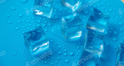 Preview: Ice cubes on a blue background. Selective focus.