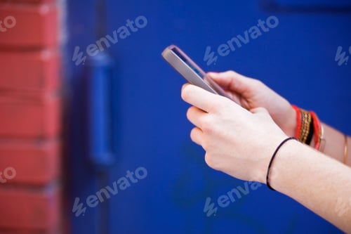 Preview: Close-up of women's hands using mobile phone