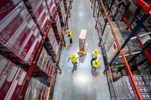 Preview: Warehouse workers at work between rows of tall shelves full of packed boxes, top view