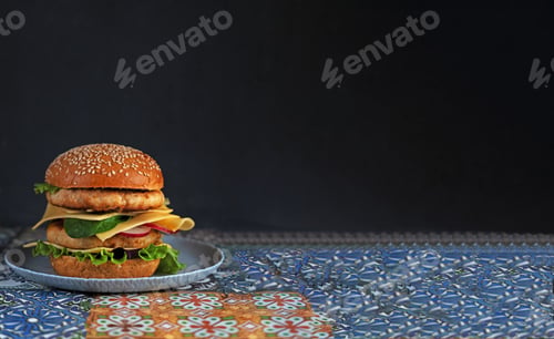 Preview: Classic hamburger with two cutlets on a plate. Food banner with place for text. Chicken cheeserurger