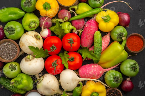 Preview: top view fresh vegetables cucumbers radish tomatoes onions with seasonings on a dark background