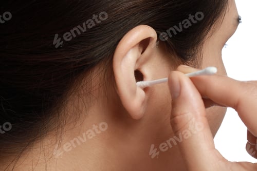 Preview: Woman cleaning ear with cotton swab on white background, closeup