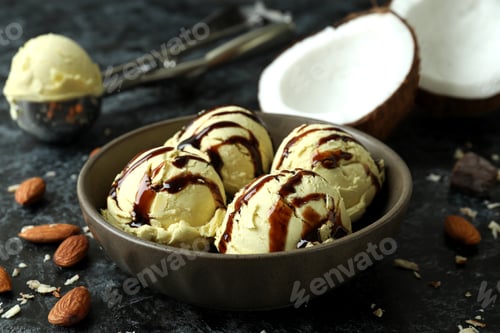 Preview: Bowl with ice cream balls and ingredients on black smokey table