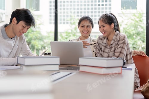 Preview: Group of Happy Students Studying Together with Laptops and Books in a Bright Modern Classroom